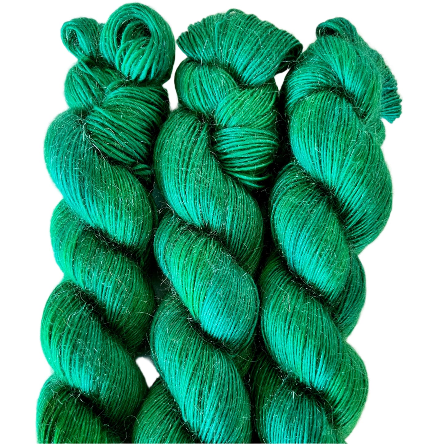 Three skeins of green yarn on a white background