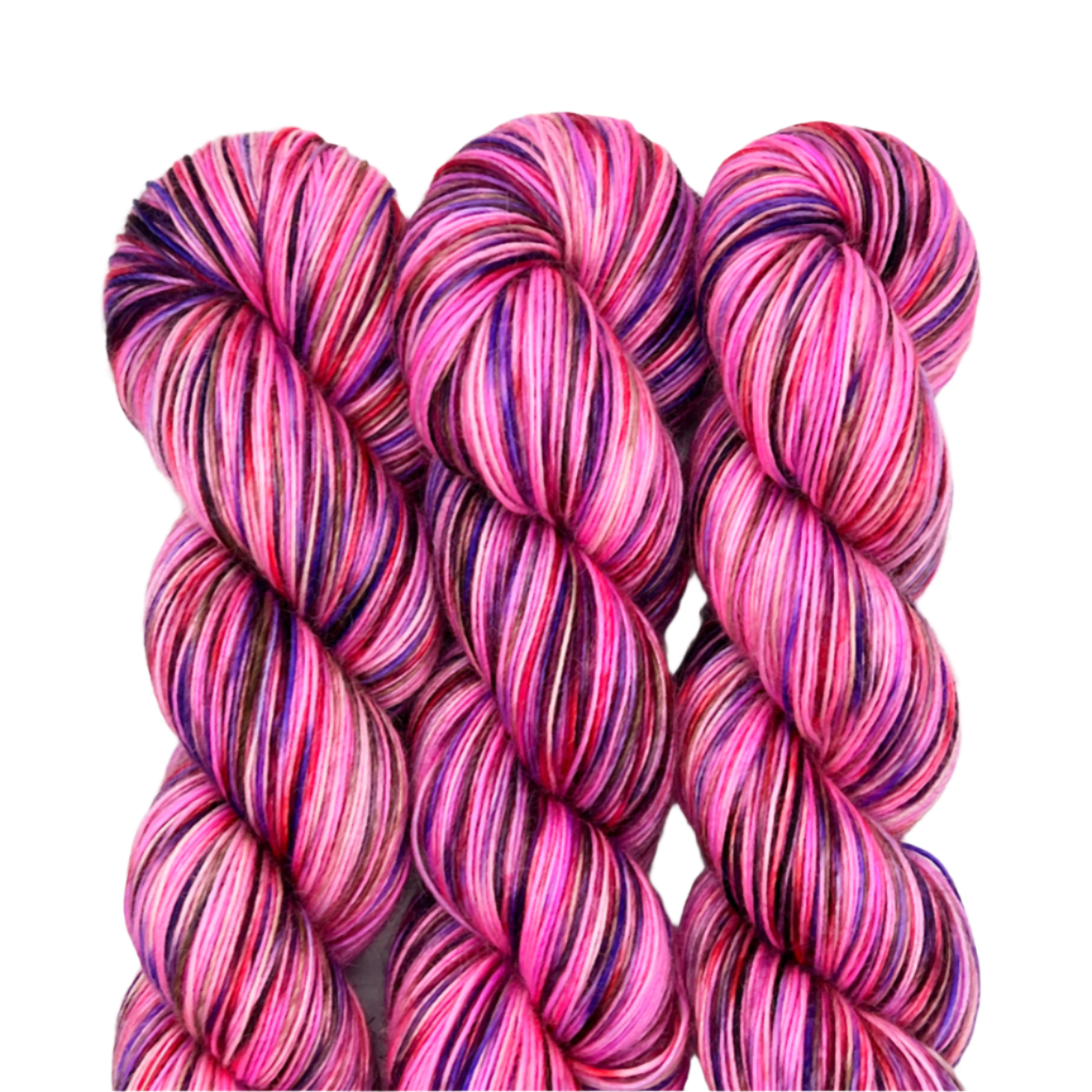 Three skeins of pink variegated yarn on a white background