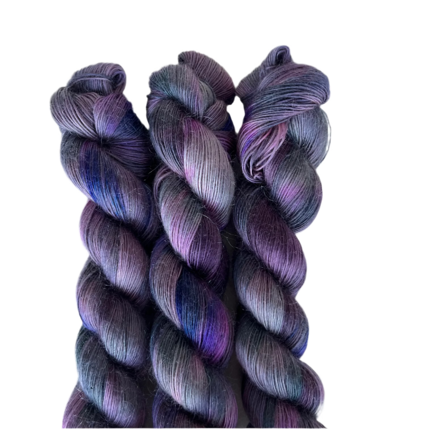 Three skeins of multicolored yarn on a white background