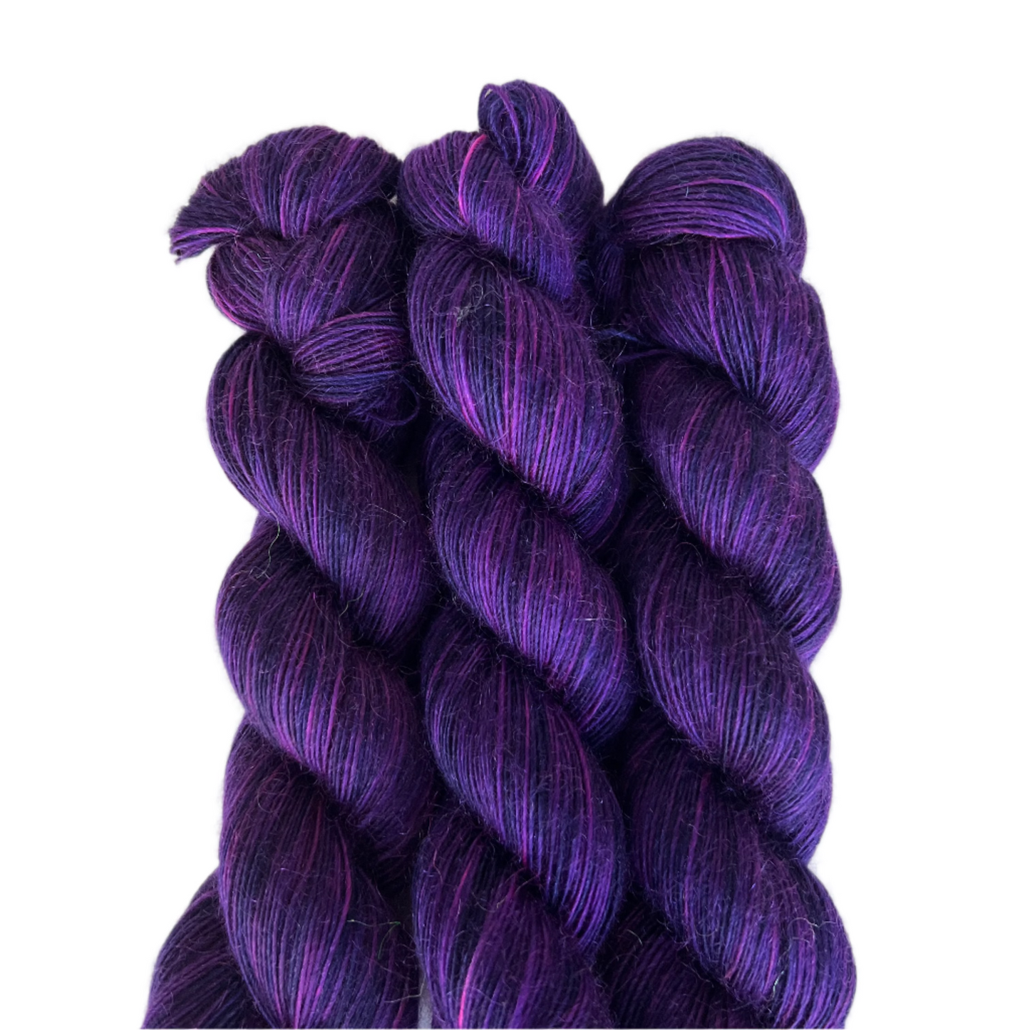 Three skeins of purple yarn on a white background