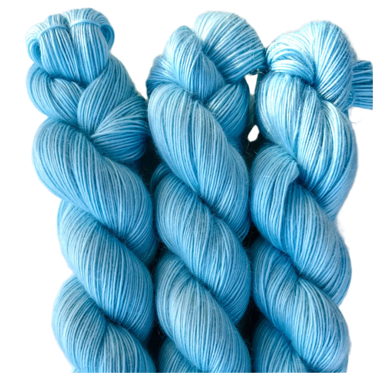 Three skeins of pale blue yarn on white background